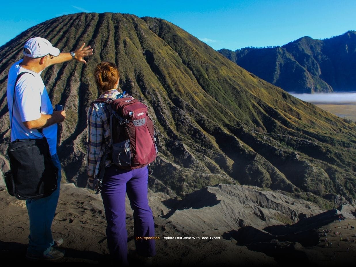 Travelers climbing stairs to Mount Bromo crater