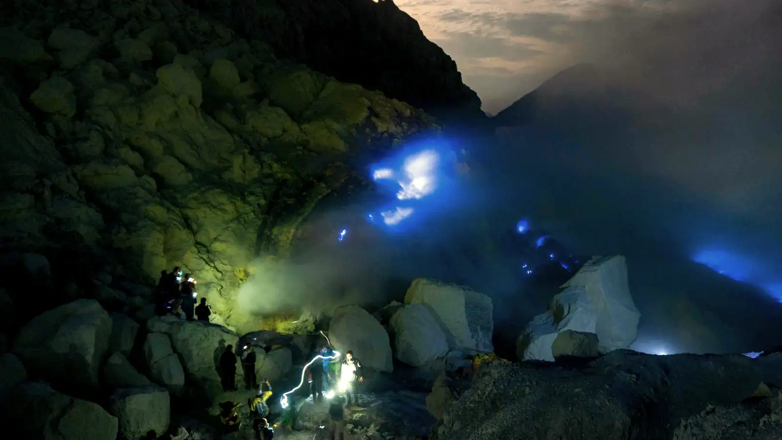 Hiking trail at Ijen Crater with sulfur clouds