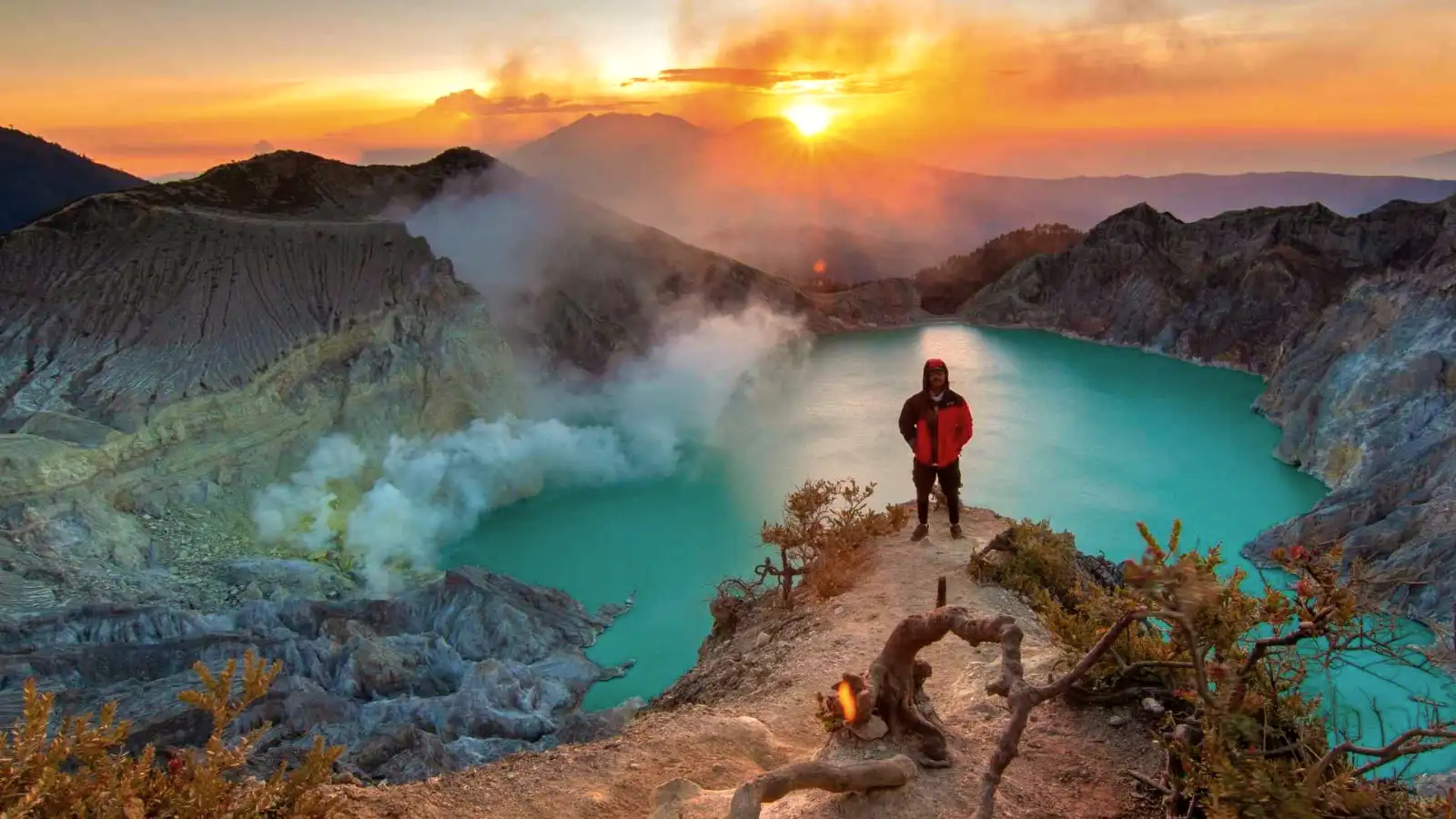 Hikers walking along the ridge of Ijen Crater