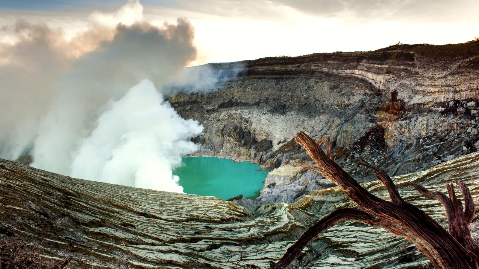 Sunrise over the acid lake of Ijen with orange and teal sky tones