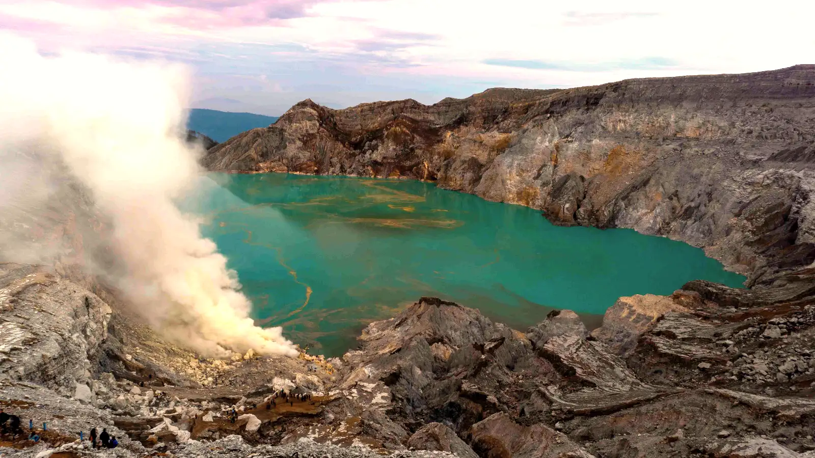 Miners carrying heavy baskets of sulfur at Ijen Crater