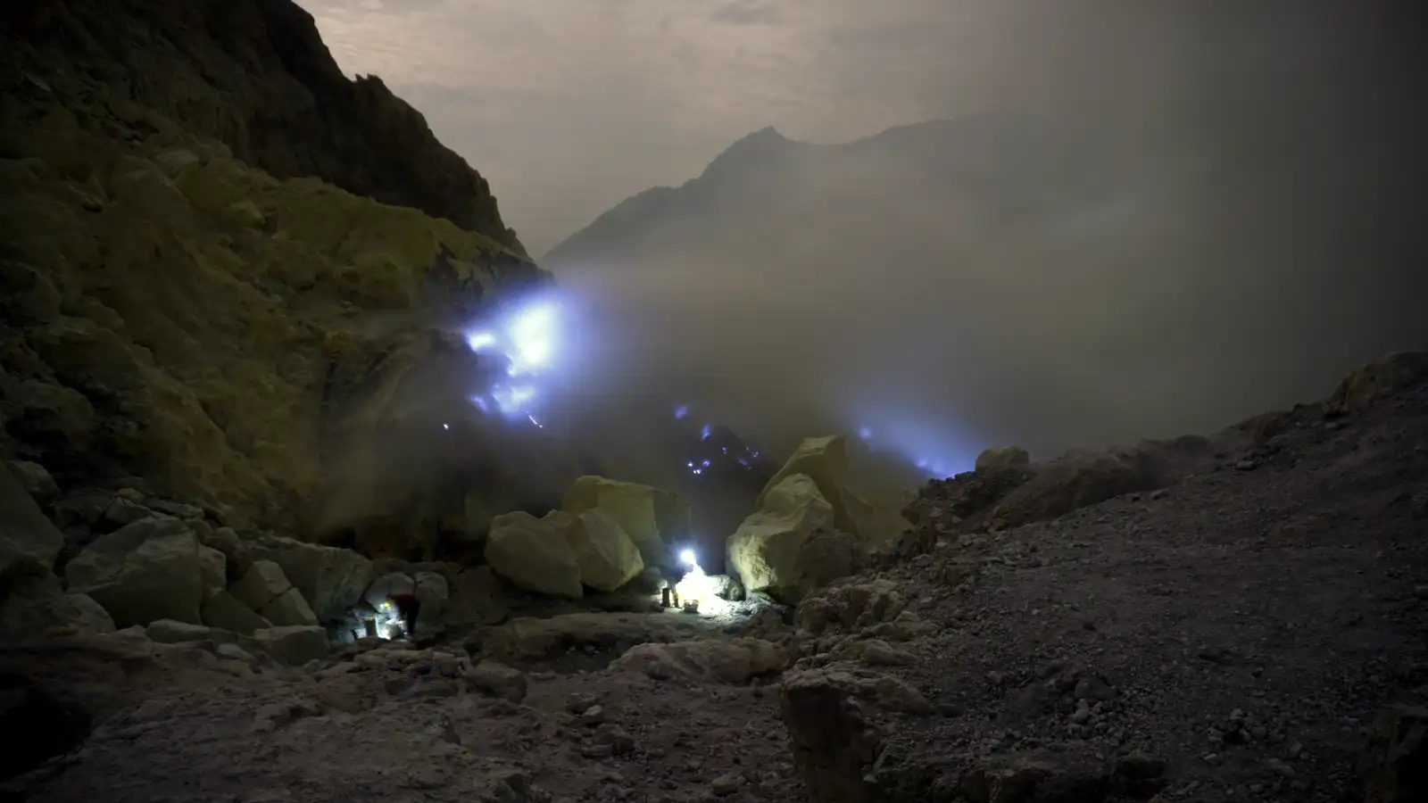 A local sulfur miner carrying heavy loads of sulfur out of the Ijen Crater