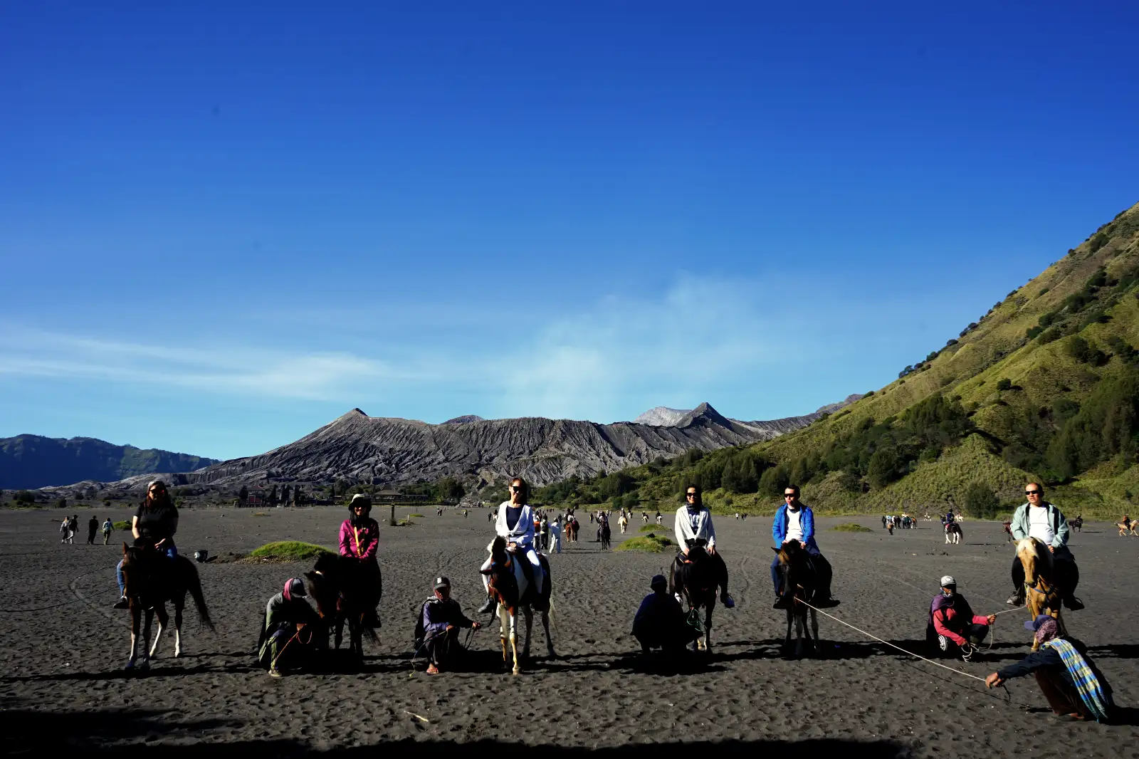 The Hike to Bromo Crater Travelers hiking on the dusty trail toward the Mount Bromo crater rim