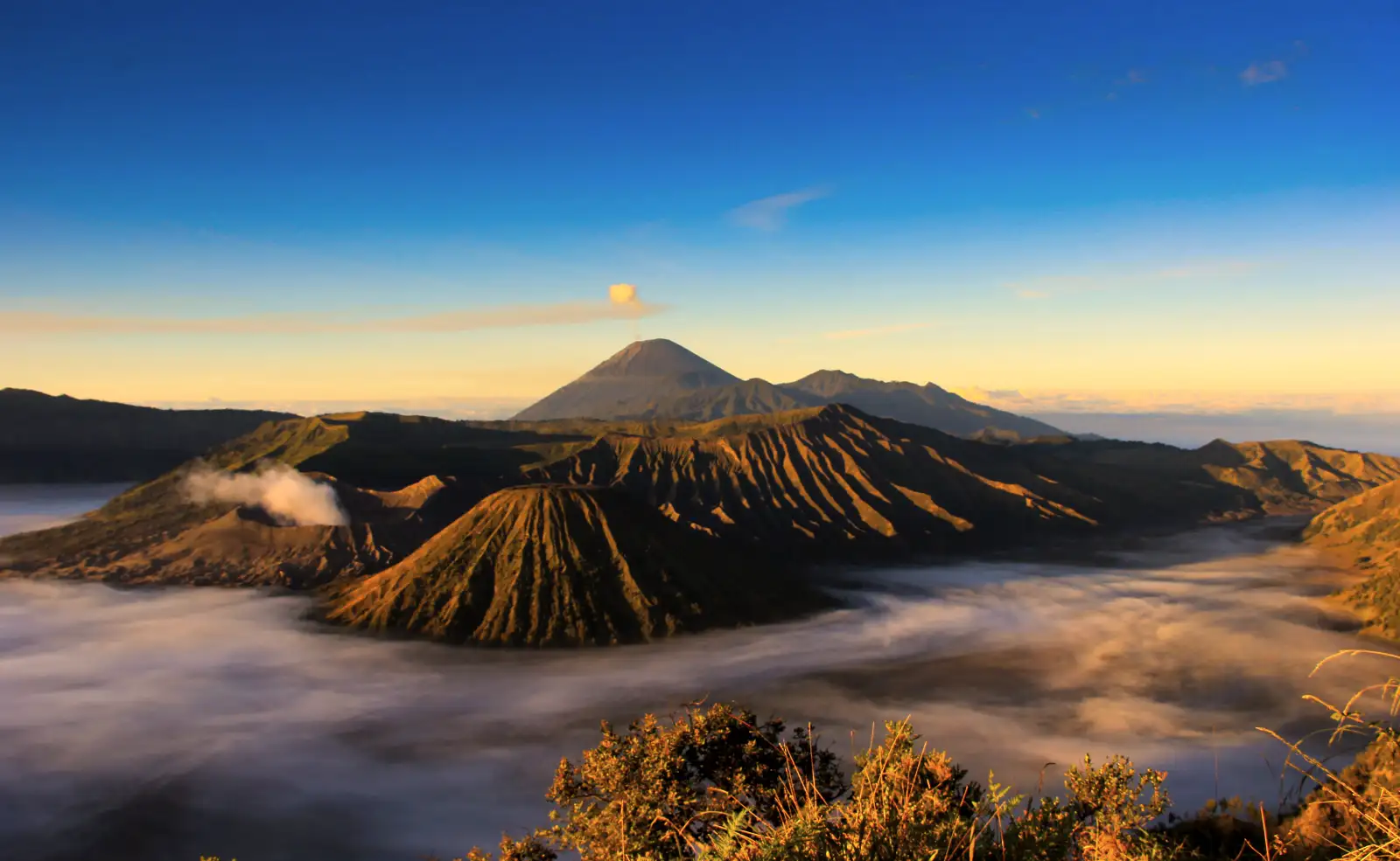 Volcano Trekking Adventure Travelers hiking on the rim of a volcano in East Java