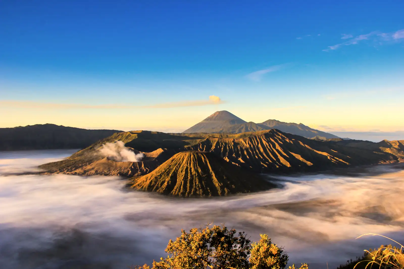 Travelers hiking the rim of a volcano in East Java Indonesia
