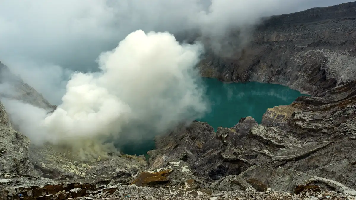 The spectacular sunrise at Kawah Ijen Ijen Crater sunrise with blue sky and yellow sulfur rocks
