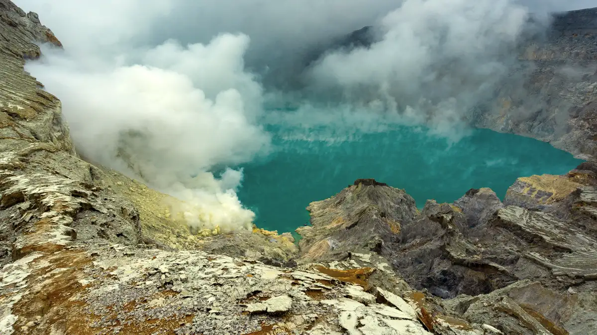 Ijen Crater turquoise acid lake at sunrise