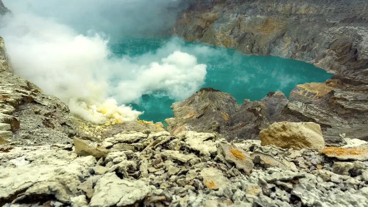 Stunning Kawah Ijen Sunrise Views Vibrant turquoise volcanic lake of Kawah Ijen with rising sulfur gas during sunrise