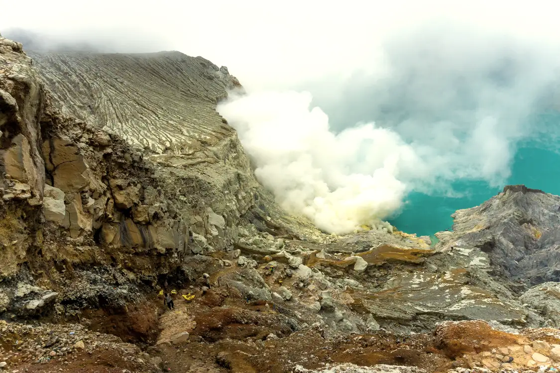 Hardworking sulfur miners at Ijen Crater Sulfur miners carrying baskets at Kawah Ijen East Java