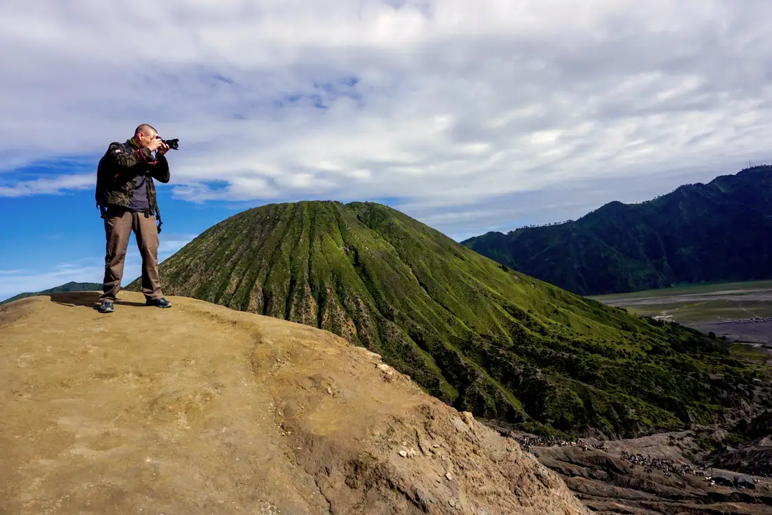 Beginner Hiking Guide to Mount Bromo Hikers standing near the rim of Mount Bromo crater at sunrise