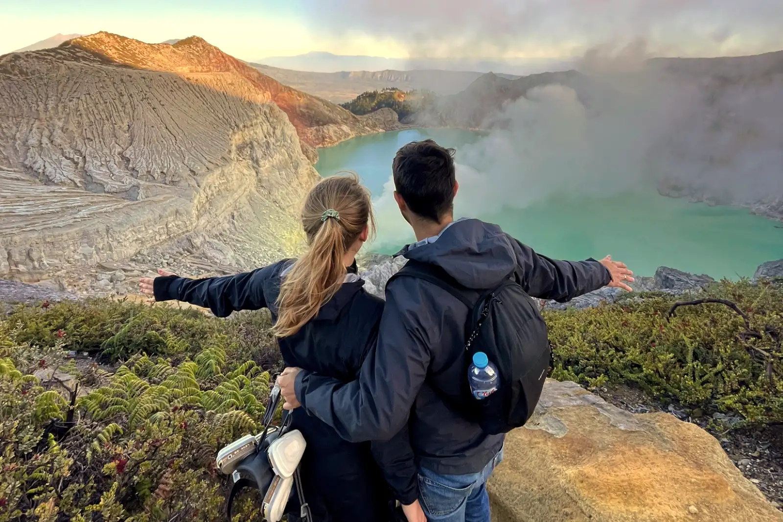 Ijen Crater Logistics and Route Planning Sulfur miners at Ijen Crater lake during sunrise